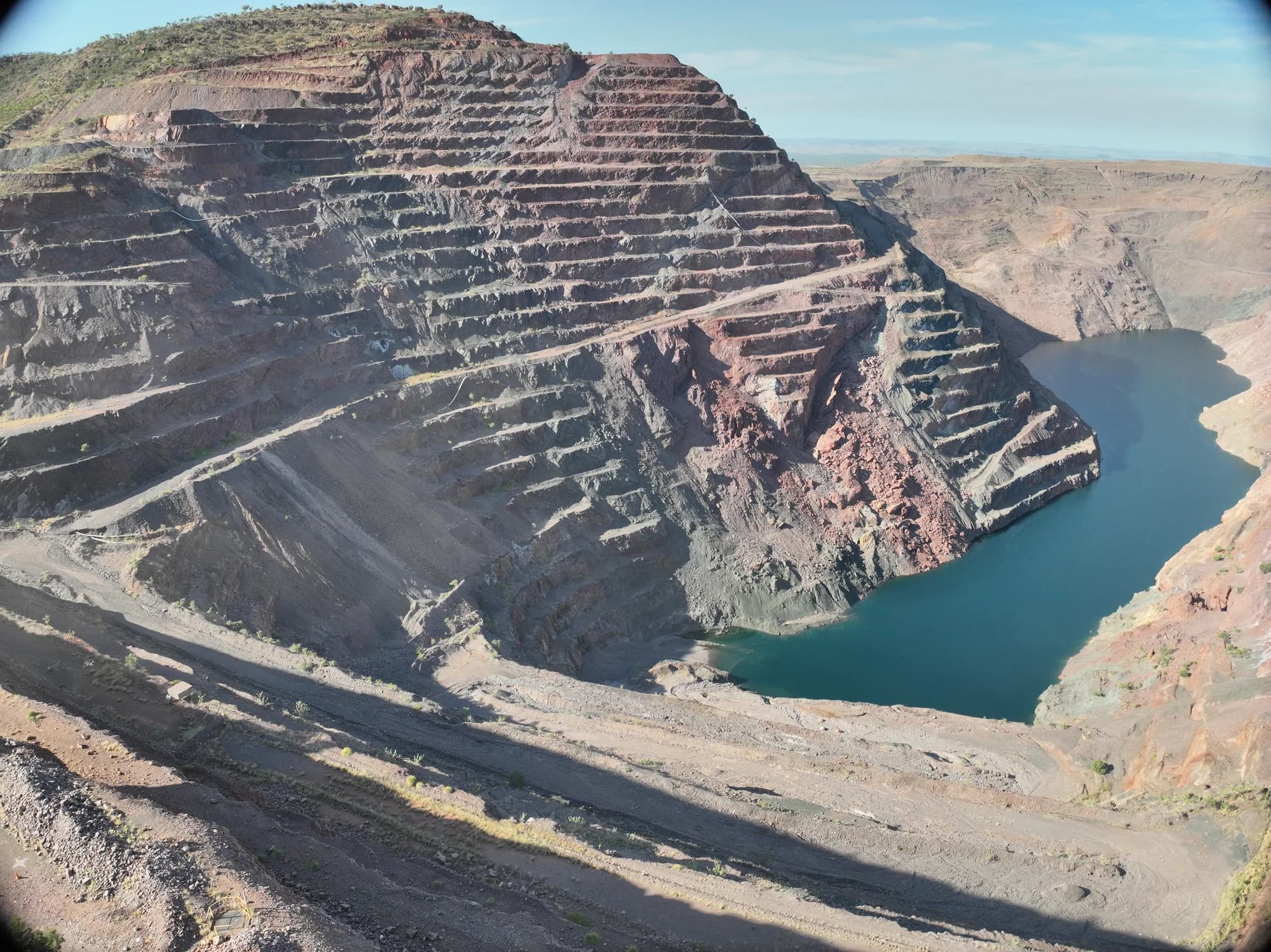 Wide view of the terraced Argyle Diamond Mine pit and water below