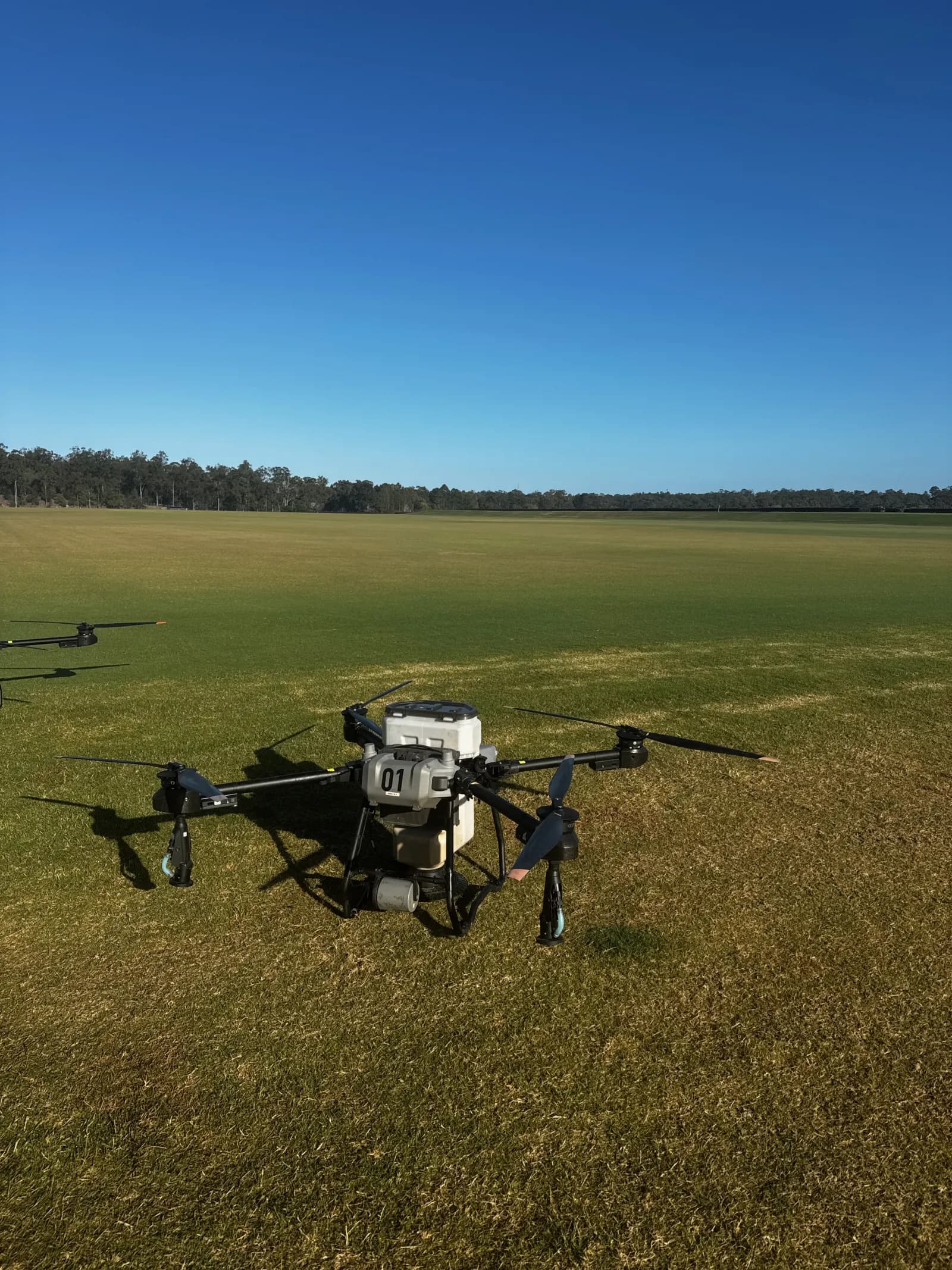 Application aircraft positioned on a large open grass treatment area