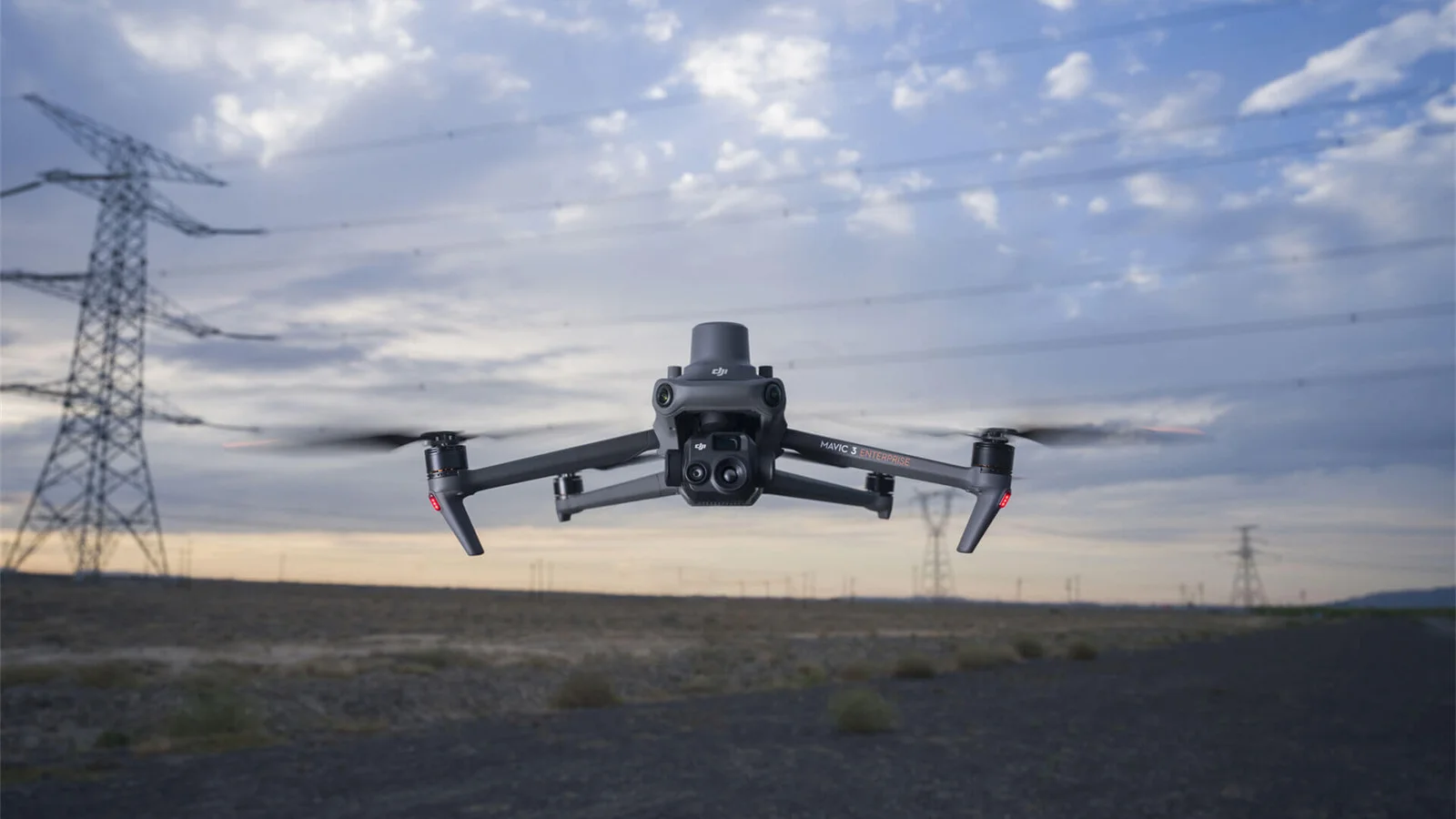 DJI Mavic 3T flying near power transmission infrastructure.