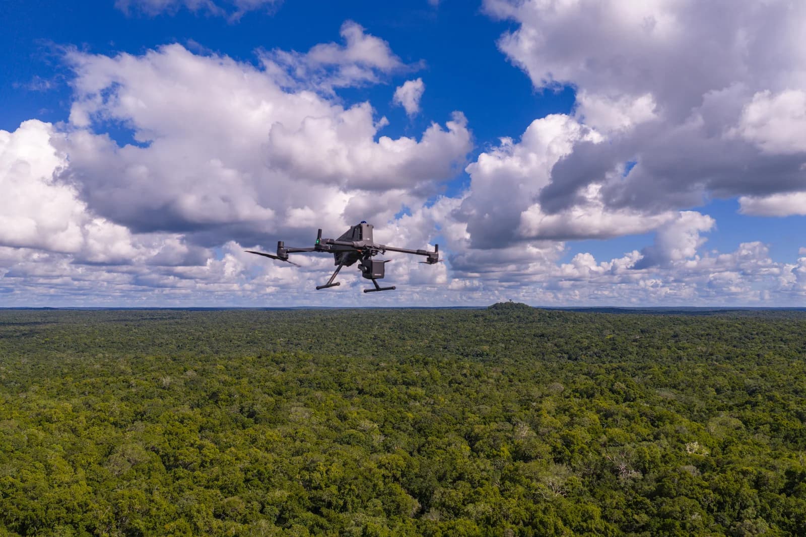 DJI Matrice 400 with LiDAR payload flying above forest in Guatemala.