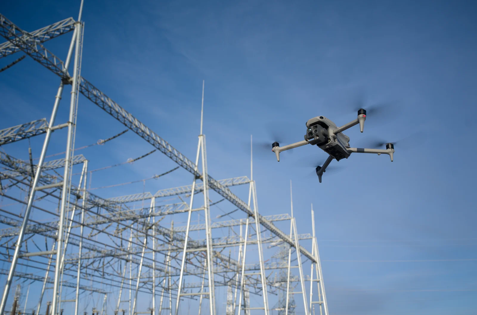 Matrice 4 Series aircraft flying beside a power substation.