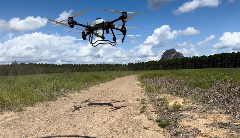 Spraying drone in flight over Australian forestry