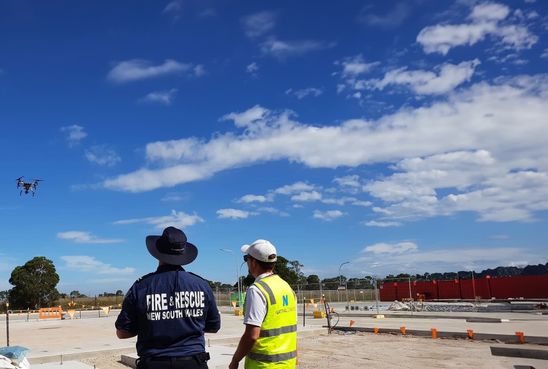 Pilot and spotter coordinating a drone flight during training